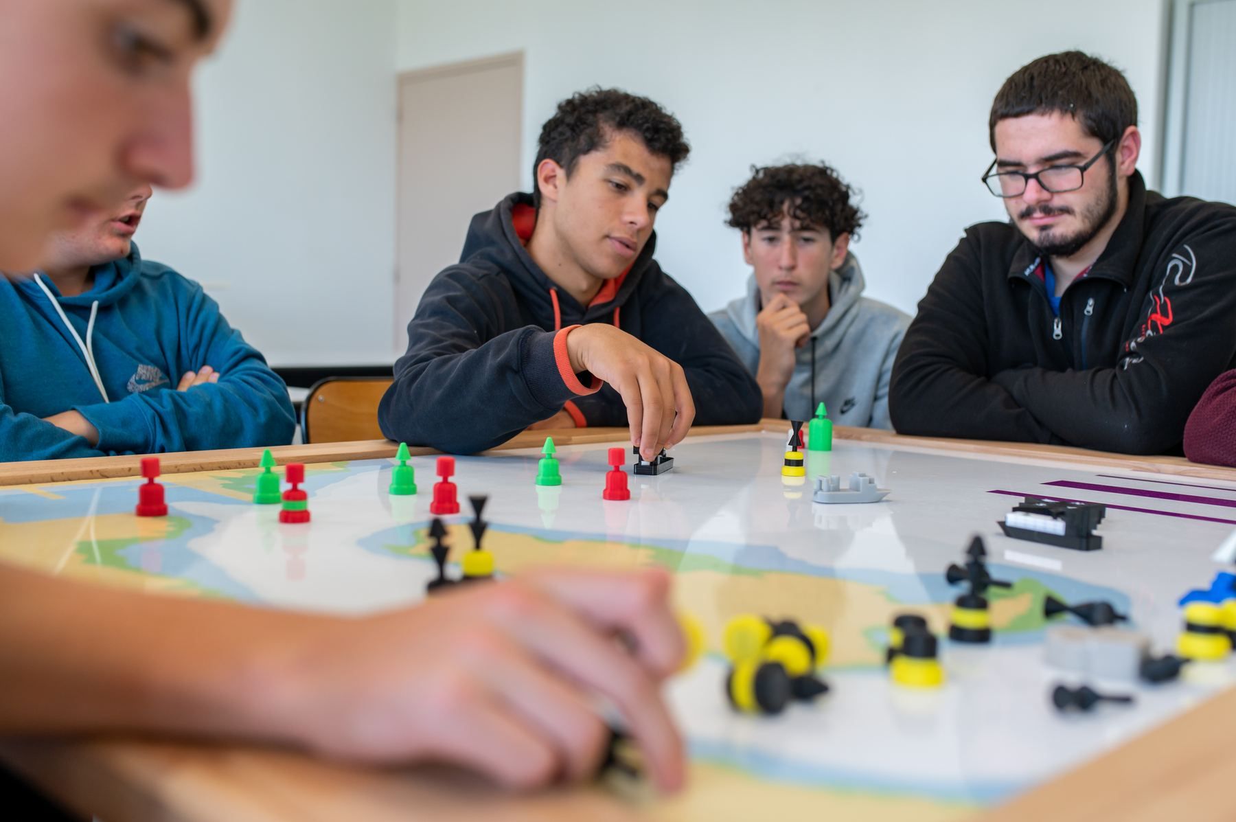 Students discussing around the board