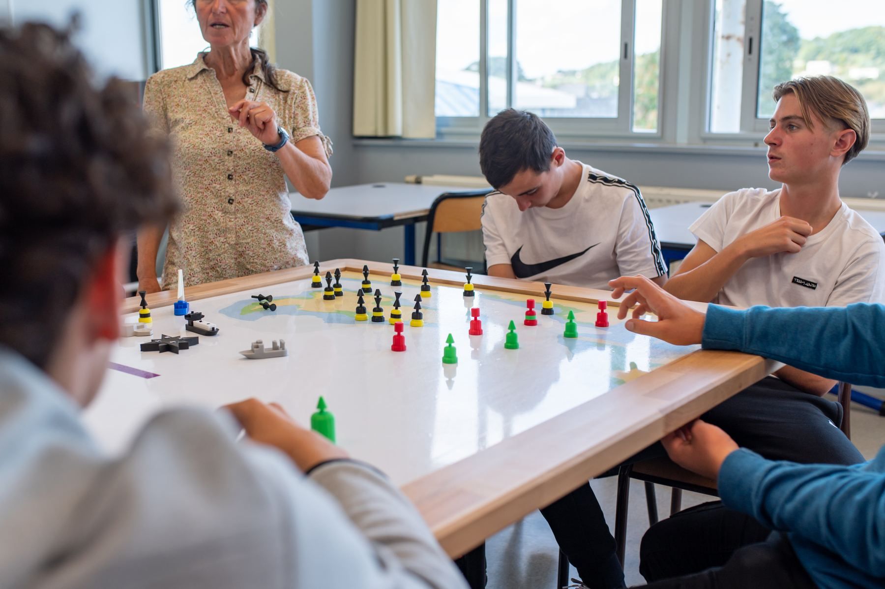 Instructor questioning students around the board