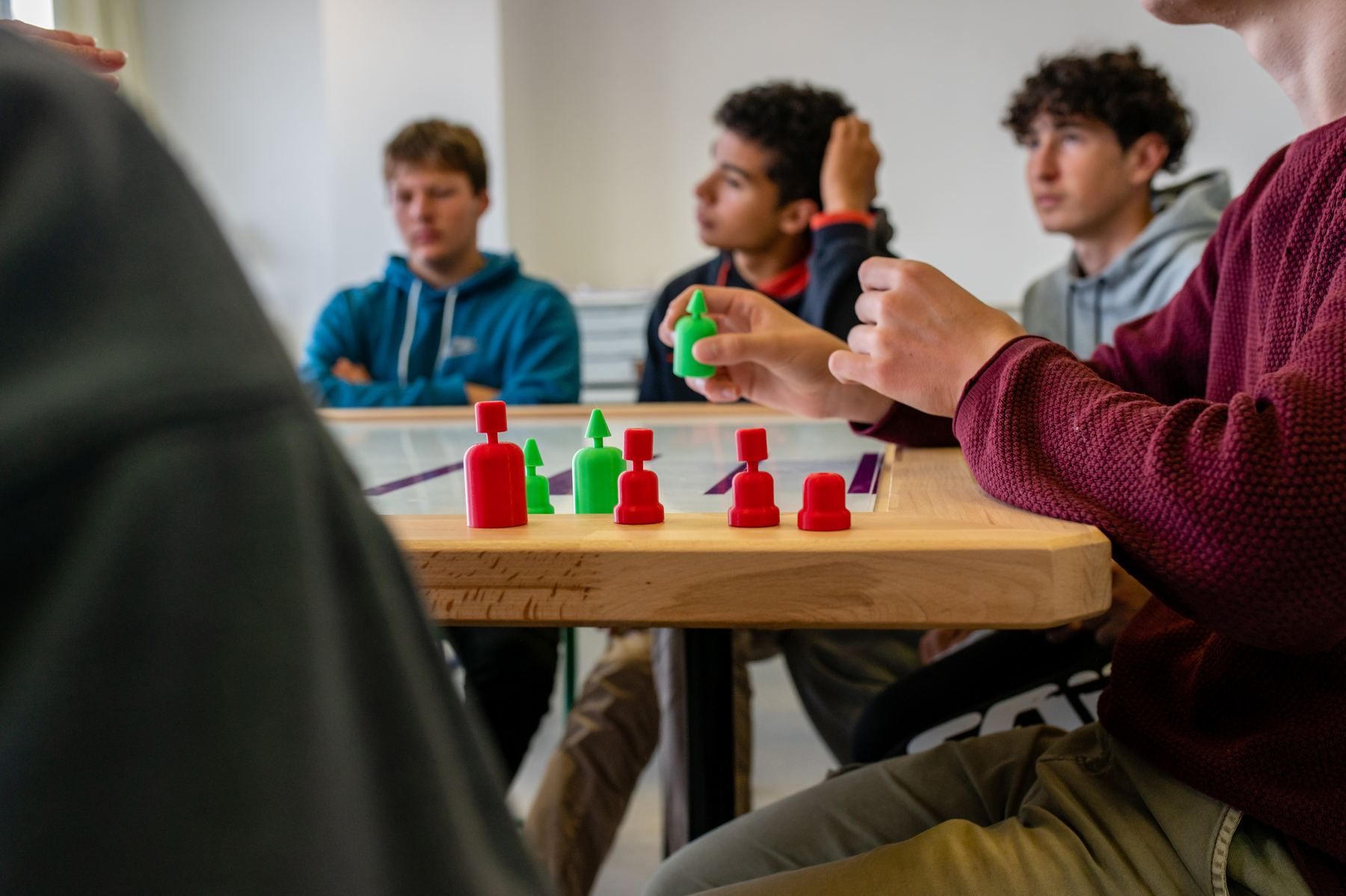 Student placing red and green buoys on the board